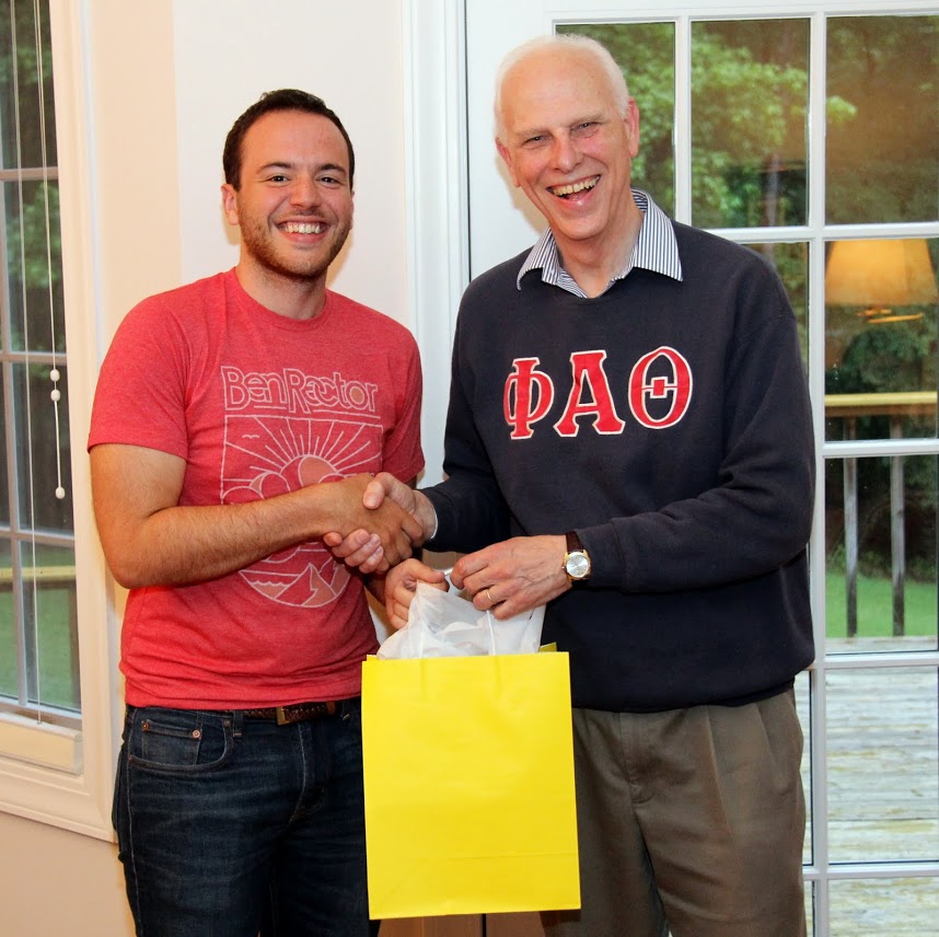Jeremy Ebert (left) shows joy in accepting congratulations from Dr. Stephen Carls at the Phi Alpha Theta cookout on May 12, 2017, for completing a bachelor of science program in business administration and history at Union University.