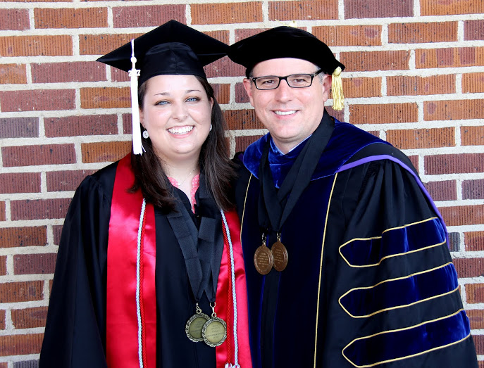 Emily Littleton and Dr. Keith Bates join together for a photo prior to Union University's undergraduate commencement exercises on May 20, 2017, to display the academic excellence medals they earned as students at Union University. Littleton received the 2017 academic excellence medals in history and journalism and Bates earned the 1996 academic excellence medals in history and Greek.