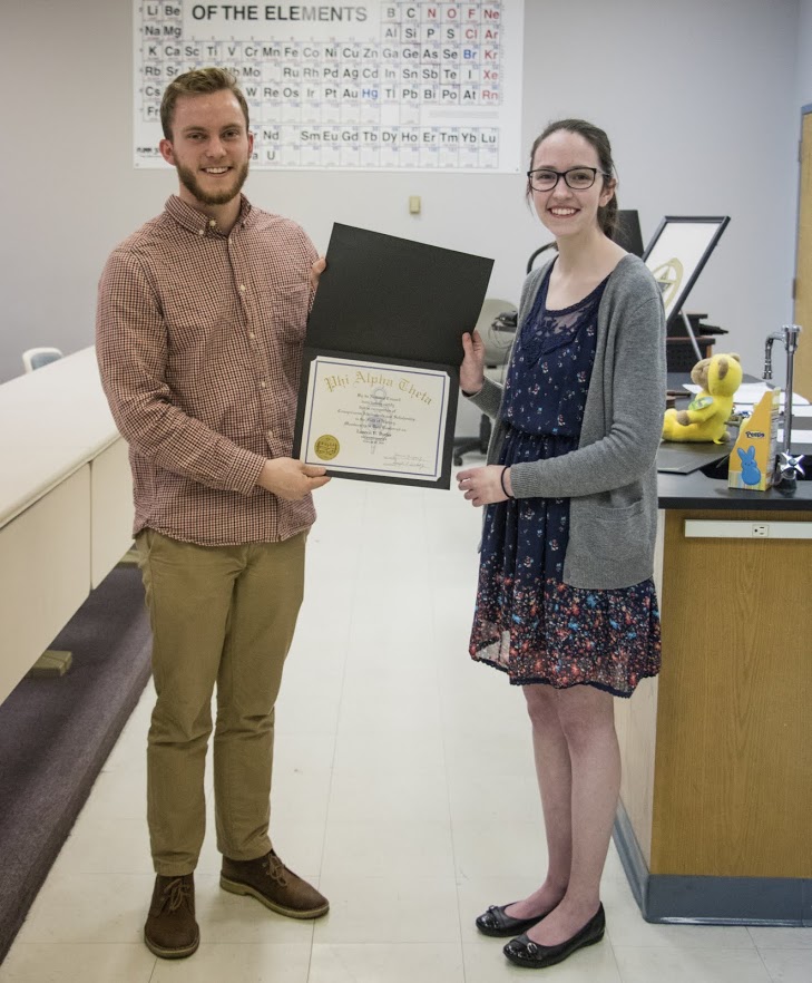 Seth Reid, the Delta-Psi chapter president, presents a Phi Alpha Theta membership certificate to Lauren Butler on February 27, 2018. Photo by Janelle Vest