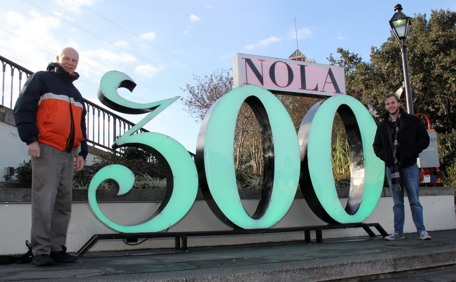Dr. Stephen Carls (left) and Seth Reid stand by a sign on January 7, 2018, that celebrates the 300th anniversary of the founding of New Orleans in 1718.