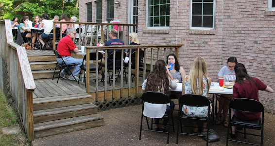 Attendees at the 26th Annual Phi Alpha Theta/History Department Cookout on May 12, 2018, enjoy their time together in the back yard of the Carls's home.