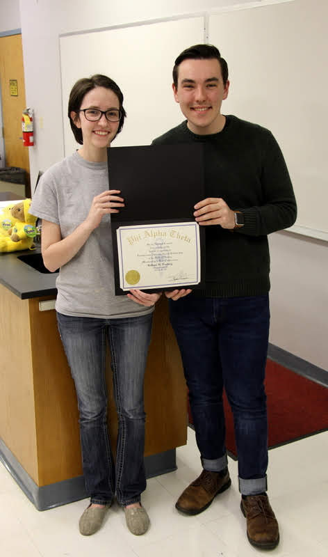 Delta-Psi President Lauren Butler presents Mac Hazlerig with his Phi Alpha Theta membership certificate on February 26, 2019.
