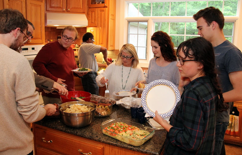 Attendees at the Phi Alpha Theta cookout on May 11, 2019, go through the food line. They are (going clockwise, starting on the left) Luke Sower (back to camera), Dr. Keith Bates, Nathan Heatherly, Tracy Newsome, Brenda Briley, Mikayla Simpson, Jack Waters, and Lillie Salazar.