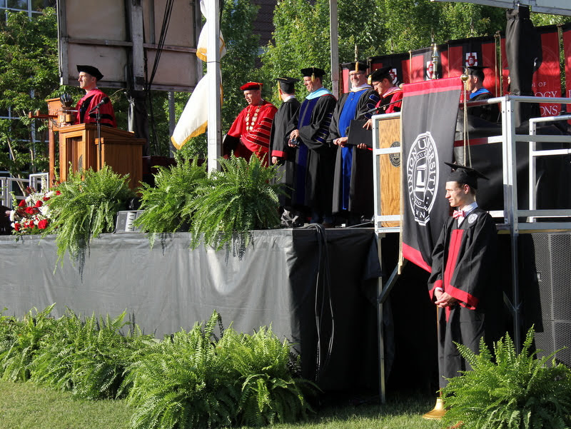 Participants in Union University's spring undergraduate commencement program stand on the graduation stage during the processional on May 18, 2019.