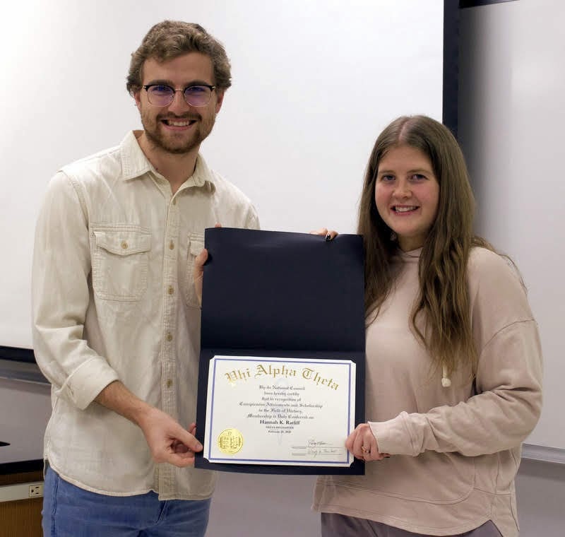 Hannah Ratliff accepts her Phi Alpha Theta certificate of membership from Delta-Psi President Luke Sower at the chapter's spring plenary meeting on February 25, 2020. Photo by Naomi Mengel