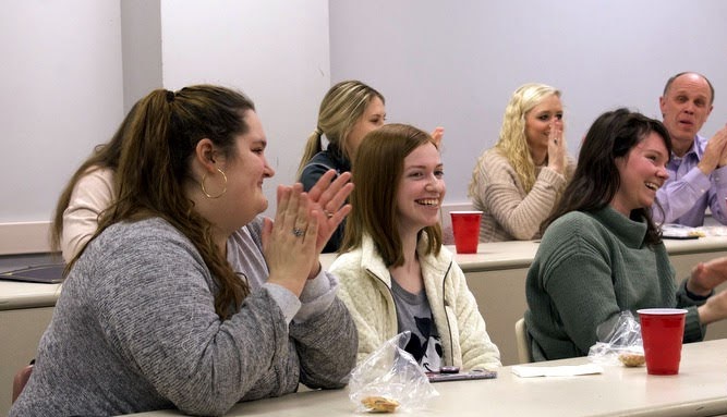 Phi Alpha Theta members applaud for Savannah Wright as the Delta-Psi chapter's president for 2020-2021. She is seated in the middle of the front row. Others in the photo are: (front row, left and right) Sandra Allen and Audrey Cagle; (visible in back row, left to right) Addison Osborne, Jennifer Briley, and Robert Briley. Photo by Naomi Mengel