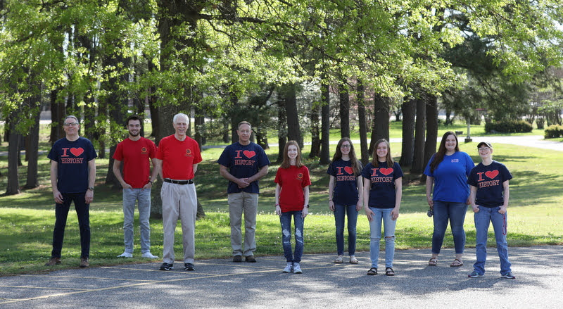 Members of the Delta-Psi chapter of Phi Alpha Theta join together for a photo during their T-shirt Spirit Day on April 12, 2021. They are (left to right) Dr. Keith Bates, Jack Waters, Dr. Stephen Carls, Dr. Henry Allen, Savannah Wright, Anne Adams, Abbie Hobson, Sandra Allen, and Elizabeth Blevins. Photo by Kristi Woody