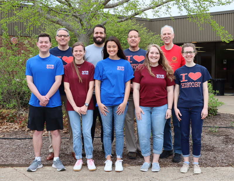 Phi Alpha Theta members assemble for a group photo at the Delta-Psi chapter's annual Phi Alpha Theta T-shirt Spirit Day on April 11, 2022. They are: (front row, left to right) Jack Jenkins, Anna Yadkowski, Makayla Baker, Breanna Edmiston, and Anne Adams; (back row, left to right) Dr. Keith Bates, Nicholas Terra, Dr. Henry Allen, and Dr. Stephen Carls. Photo by Alice-Catherine Carls