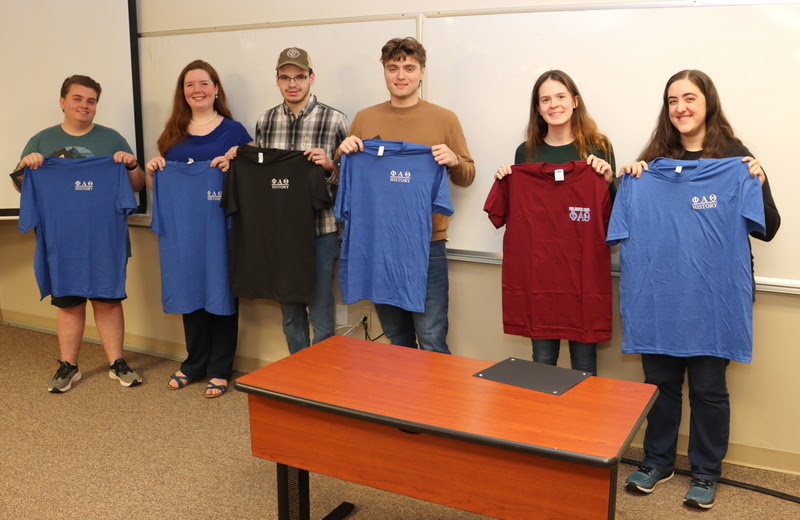 The Delta-Psi chapter's new members show off the Phi Alpha Theta T-shirts they received as part of the induction ceremony at the chapter's spring plenary meeting on February 20, 2023. They are (left to right) Austin Alexander, Abigail Gilbert, William Houston, Jacob Frederick, Samantha Poore, and Joy Brown.