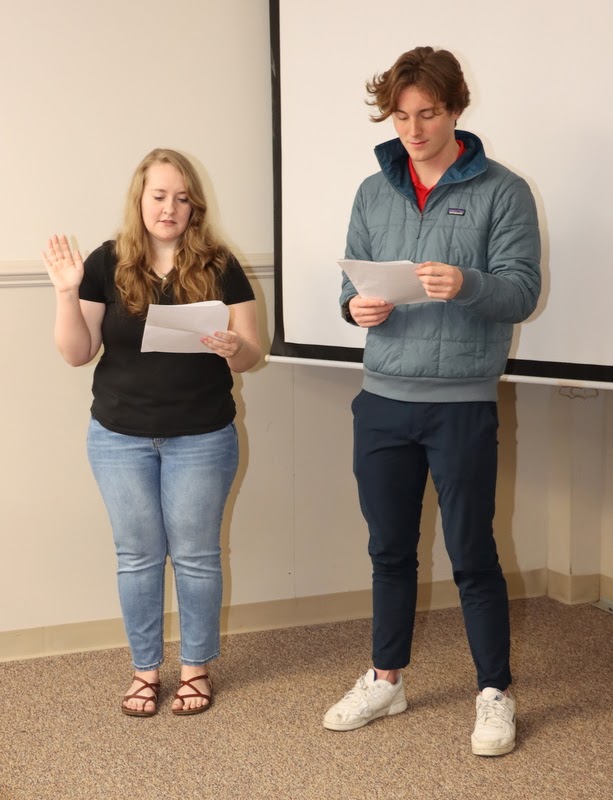 Delta-Psi Chapter Vice President Breanna Edmiston conducts the induction ceremony for new Phi Alpha Theta members on February 20, 2023, while President Tad Binkley observes.