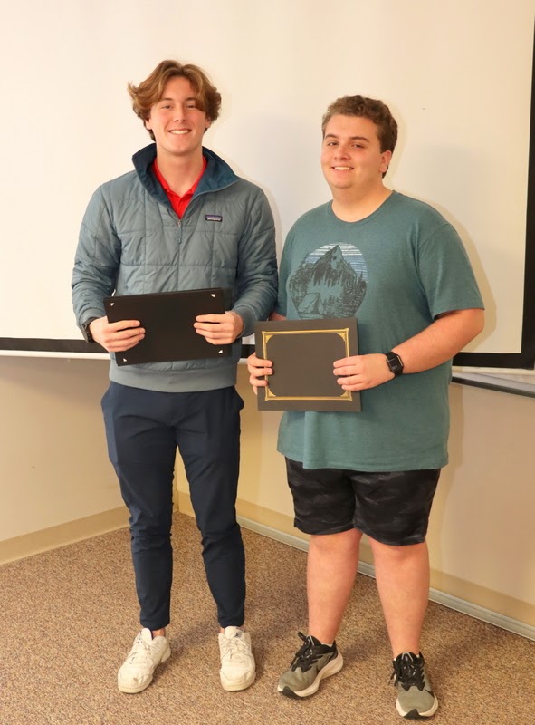 New Phi Alpha Theta member Austin Alexander (right) stands with Delta-Psi President Tad Binkley after receiving his membership certificate at the chapter's spring plenary meeting on February 20, 2023.