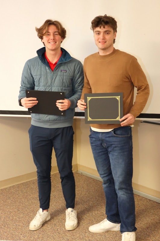 New Phi Alpha Theta member Jacob Frederick (right) stands with Delta-Psi President Tad Binkley after receiving his membership certificate at the chapter's spring plenary meeting on February 20, 2023.