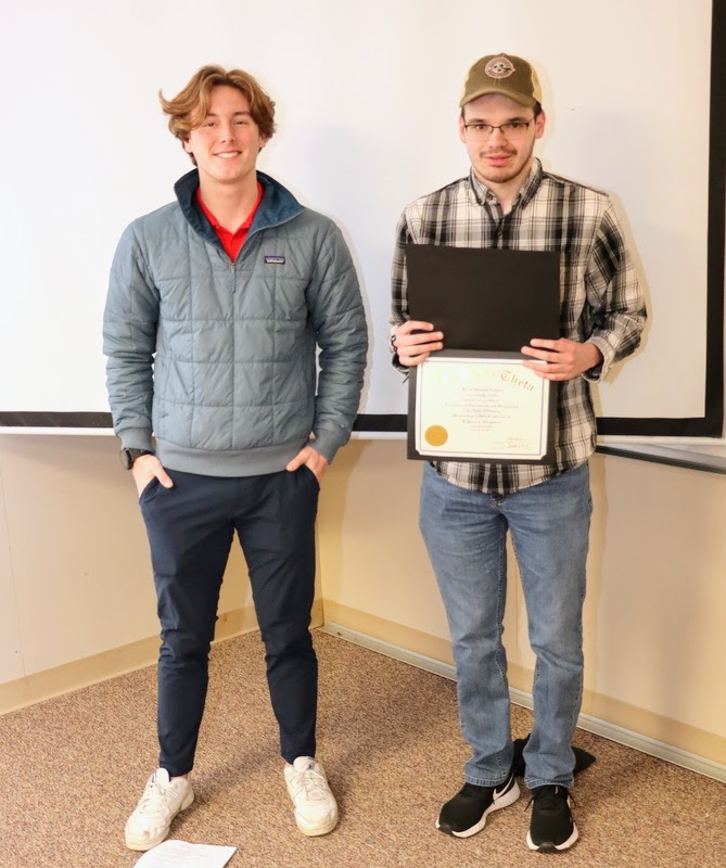 William Houston (right), standing with Delta-Psi President Tad Binkley, shows off his Phi Alpha Theta membership certificate  during the chapter's induction ceremony on February 20, 2023.
