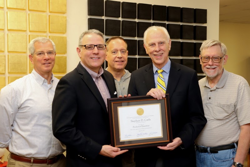 Dr. Stephen Carls (front right) receives  his Union University professor emeritus diploma from Dr. Keith Bates (front left) on May 5, 2023. Other history department members present are (back row, left to right) Drs. David Thomas, Henry Allen, and Terry Lindley.