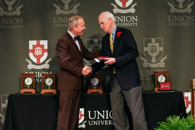 Dr. Stephen Carls (right) accepts a 40-year service award (1983-2023) from Union University President Samuel W. 