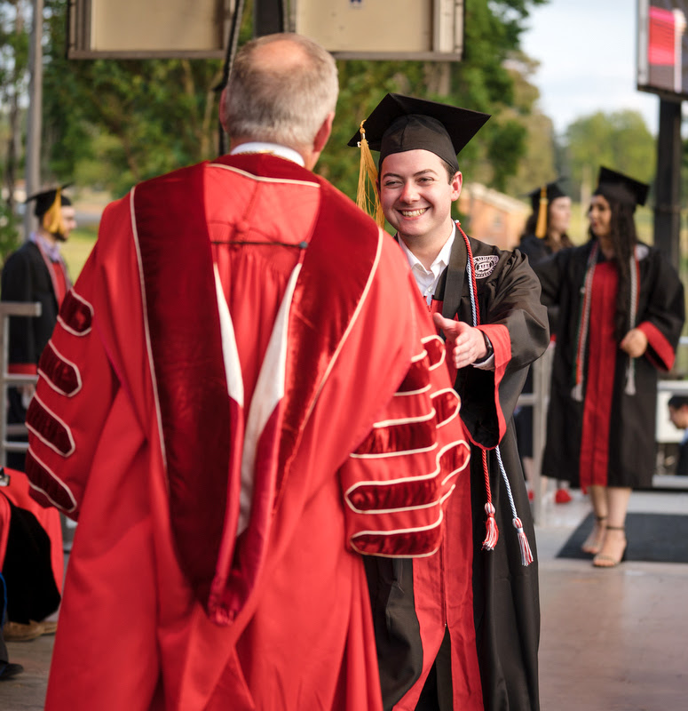 History major and Phi Alpha Theta member Jack Jenkins accepts his diploma for the completion of a Bachelor of Science degree from President Samuel W. Dub Oliver at Union University's spring graduation on May 6, 2023.