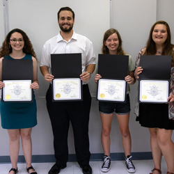 The newly members of Phi Alpha Theta's Delta-Psi chapter display their membership certificates following the fall initiation ceremony on September 24, 2019. They are (left to right) Johnna Wade, Nicholas Terra, Rebekah Lisle, and Sandra Allen. Photo by Joey Echeverria