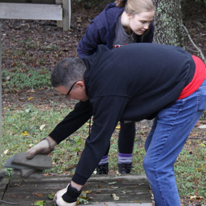 Dr. Keith Bates and Megan Ledbetter gather up small bricks for stacking at Liberty Garden Park on October 29, 2019.