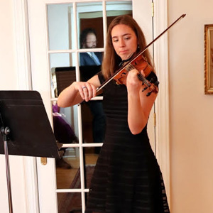 Union student Emma Otto performs a Christmas piece on her violin at the Phi Alpha Theta French Christmas dinner on December 7, 2019.