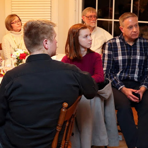 Attendees at the Phi Alpha Theta French Christmas dinner listen to violinist Emma Otto perform a Christmas song on December 7, 2019. They are (starting on the left and going clockwise) Sandra Allen, Alex Anderson, Becky Lindley, Dr. Terry Lindley, Dr. Henry Allen, Savannah Wright, and Nathan Van Neste.