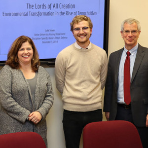 Luke Sower (second from right) stands with members of his honors thesis committee following his successful thesis defense on December 3, 2019. They are (left to right) Dr. Keith Bates, Dr. Karen Martin, and thesis director Dr. David Thomas.