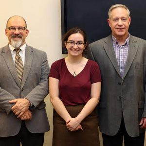 Leah Atkins stands with her history honors thesis committee after her successful thesis defense on December 9, 2019. The committee members are (left to right) Dr. Scott Huelin, Dr. Henry Allen, the thesis committee chair, and Dr. David Thomas.