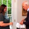 Dr. Stephen Carls presents an award bag to graduating Phi Alpha Theta member Kensie Zills at the annual Phi Alpha Theta cookout on May 8, 2015.