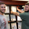 Delta-Psi President Nicholas Hancock (right) puts the chapter's 2015 Phi Alpha Theta Best Chapter Award in a history department display case on September 23, 2015, while Vice President Allen Bradley shows his enthusiasm for the chapter's success with a smile. The chapter received news of their 13th straight Best Chapter Award on September 18.