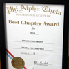 The Delta-Psi chapter's 2015 Phi Alpha Theta Best Chapter Award certificate rests on a display table at the chapter's homemade pizza party on October 16, 2015.