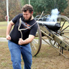 Nicholas Hancock pulls the lanyard (trigger cord) to fire a cannon at a Phi Alpha Theta-sponsored community service project at Britton Lane Battlefield on November 3, 2015.