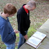 Gideon Ragland (left) and Devin Dean look at a scrapbook about the Battle of Britton's Lane at the end of a Phi Alpha Theta-sponsored community service project at Britton Lane Battlefield on November 3, 2015.