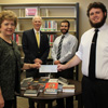 Phi Alpha Theta Chapter President Nick Hancock (right) presents a Best Chapter Award check to Library Director Anna Beth Morgan at a special ceremony in Union's library on December 3, 2015. In the background are Delta-Psi Chapter Faculty Advisor Dr. Stephen Carls (left) and Vice President Allen Bradley.