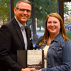 Kathryn Mitchell receives a certificate of commendation and a book from Dr. Keith Bates at the history awards banquet for her excellent paper presentation at the Tennessee Phi Alpha Theta Regional Conference on April 2. Photo by MiKalla Cotton