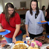 Dr. Stephen Carls grills hamburgers and hot dogs while Dr. Terry Lindley observes at the annual Phi Alpha Theta cookout on May 13, 2016.