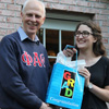 Dr. Stephen Carls presents a graduation bag to Olivia Winters at the Phi Alpha Theta cookout on May 13, 2016.