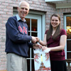 Dr. Stephen Carls congratulates Savannah German on the completion of her master's degree in library science from Texas Woman's University during a program at the history department cookout on May 13, 2016.