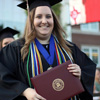 Hannah Conway shows delight after receiving her diploma at Union University's commencement services on May 21, 2016.