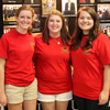 Phi Alpha Theta student leaders Beth Adams (left to right), Kathryn Mitchell, and Jordan Sellers stand in front of the history display table during the Student Organizations Fair on August 22, 2016. They represented the history department at the fair.