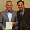 Drs. Stephen Carls (left to right), Samuel W. Dub Oliver, and Sean McMeekin smile for the camera during the presentation of one of Professor McMeekin's books to Dr. Oliver at a dinner on October 3, 2016.