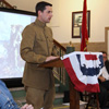 Weakley County Mayor Jake Bynum (standing), playing the role of First Lieutenant William Bledsoe, reads a letter about Second Lieutenant Herbert Jones, his World War I soldier friend, as part of a short living history skit performed at the Weakley County Courthouse on November 6, 2016. Cynthia Jones (left), in the role of Herbert Jones's mother, listens intently to what Bledsoe has to say. The program at the courthouse was the final presentation of the Tennessee Great War Commission's weekend symposium on the First World War.