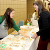 Delta-Psi chapter member Jordan Sellers (left) sells a package of Madeleine tea cakes to Savannah Patterson at the Phi Alpha Theta-sponsored Franco-American Confection and Bake Sale on March 22, 2017.