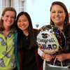 Four Phi Alpha Theta members join together for a photo at the end of the Phi Alpha Theta cookout on May 12, 2017. Three of them hold balloons in recognition of their status as graduating seniors. The students are (left to right) Beth Adams, Katherine Cheshire, Emily Littleton, and Priscilla Porter.