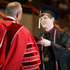 Phi Alpha Theta member Thomas Gray (right) accepts his diploma from Union University President Dr. Samuel W. “Dub” Oliver at the university's undergraduate commencement services on May 20, 2017. Photo by Kristi Woody