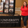 Phi Alpha Theta members Katherine Cheshire (left) and Jessica Barton, history department student hostesses at the Big Top Campus Life Fair on August 20, 2017, stand by the department display during the fair.