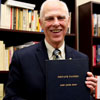 Dr. Stephen Carls holds a bound volume of the private papers of John Jeter Hurt, who served as Union University's president from 1932 to 1945. Carls received the papers on November 28, 2017, as a gift for Union University's archives from Hurt's grandsons, John and Robert Hurt. Photo by Kristi Woody