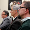 Honors thesis committee member Dr. Justin Bernard (foreground) listens to Seth Reid respond to a question at Reid's thesis defense on December 8, 2017. Sitting by him are Dr. Keith Bates (left) and Dr. David Thomas (center).