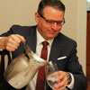 Dr. Keith Bates serves water at the French Christmas dinner on December 9, 2017.