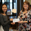 Delta-Psi Chapter Vice President Katherine Cheshire (center) presents the chapter's 2017 Phi Alpha Theta Best Chapter Award check to Library Director Melissa Moore on December 7, 2017, while Dr. Stephen Carls holds two of the books purchased with the money prize. Photo by Kristi Woody