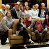 Attendees at a dinner in honor of retiring Executive Director Graydon Tunstall (seated with his wife Wendy in the chairs) pose for a photo at the beginning of the evening's festivities at the Trenasse Restaurant in New Orleans on January 5, 2018.