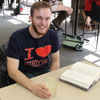 Delta-Psi Chapter President Seth Reid takes a break from reading in the Union University cafeteria on March 12, 2018, to show off his history shirt as a part of Phi Alpha Theta Spirit Day.